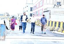 Group of people walking on a construction site near Hyderabad’s Moosarambagh Bridge.