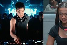 Rebel Kid DJ performing at a nightclub with a woman smiling nearby.