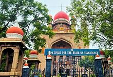 High Court for the State of Telangana building with trees and gate in front.