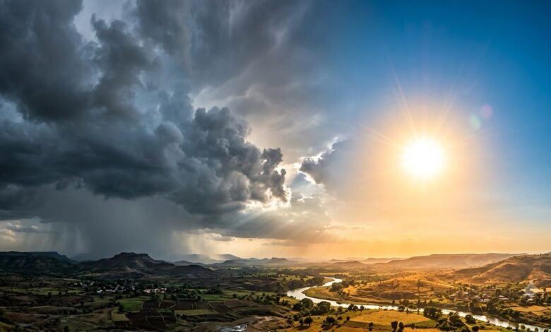 Dramatic sky with dark storm clouds and bright sun over a river valley in Telangana.