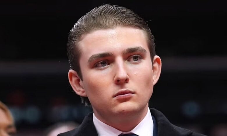 Portrait of a young man with slicked-back hair and serious expression.