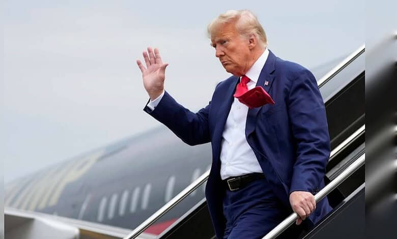 Former US President Donald Trump waves as he disembarks from an aircraft in Turkey.
