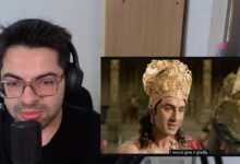 YouTuber recording a reaction video to Ramayana trailer with headphones and microphone.