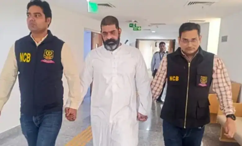 Virender Baisoya escorted by NCB officers after return to India.