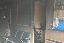 Inside HDFC bank showing burnt furniture and damaged interior after fire.