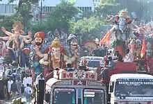 Ganesh idols and festive floats during immersion procession in Hyderabad.