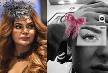 Rakhi Sawant in a stylish black hat and makeup, looking to the side with a confident expression.