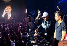 Emraan Hashmi DJing at Hyderabad event with crowd and large screen behind him.