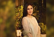 Katrina Kaif with long dark hair and elegant attire at an outdoor event.