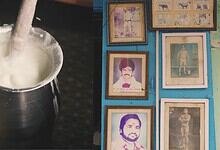 A traditional Indian milk shop with framed photographs on the wall in Hyderabad's Begum Bazar.
