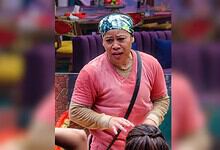 Mary Kom in a pink top and headscarf, speaking passionately in a room with purple furniture.