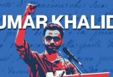 Umar Khalid raising his fist during a speech at a rally or protest.