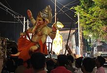 Large idol of Lord Ganesha during Ganesh Chaturthi celebration at night.