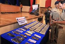 Hyderabad Police Commissioner VC Sajjanar looks at the recovered mobile phones