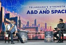 Telangana's strength highlighted at A&D and Space event with speakers on stage.
