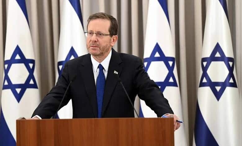 Israel President Isaac Herzog at podium.