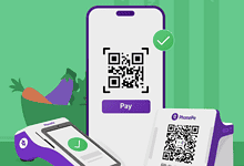 Smartphone displaying PhonePe QR code for digital payment with a checkmark.