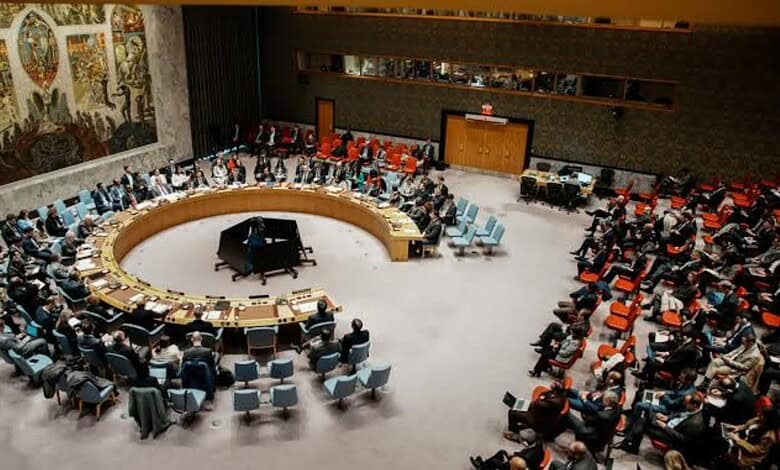UN Security Council members seated in a large circular chamber during a meeting on Iran sanctions.