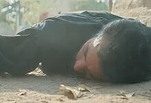 Pakistani man lying on the ground in a scene from a drama series.