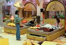 Bigg Boss 20 housemates engaging in a discussion in the colourful house setting.