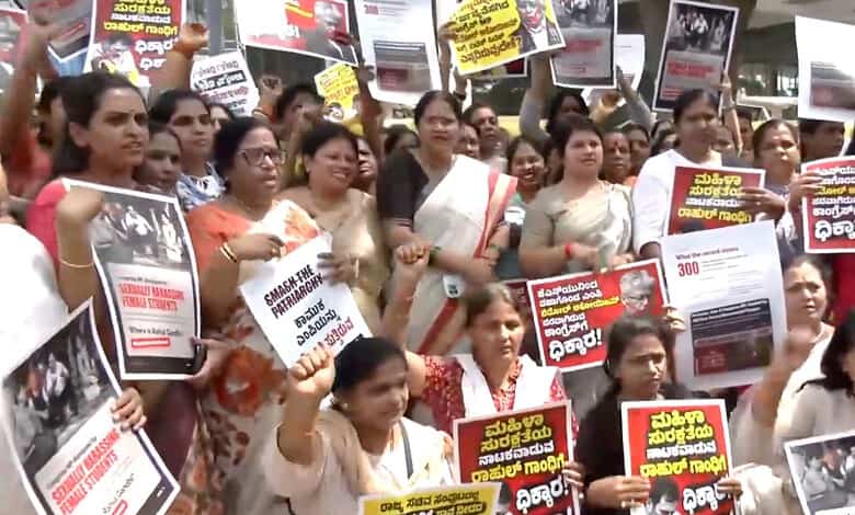 Women protesters holding placards during demonstration for women's rights in India.