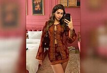 Khushi Kapoor taking a mirror selfie in a pink-themed room, wearing a traditional embroidered outfit.