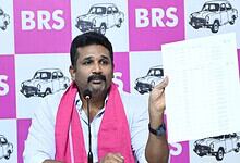 Revanth Reddy holding a document during a press conference at BRS event.