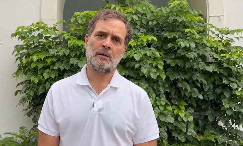 Rahul Gandhi speaking outdoors with greenery in the background.