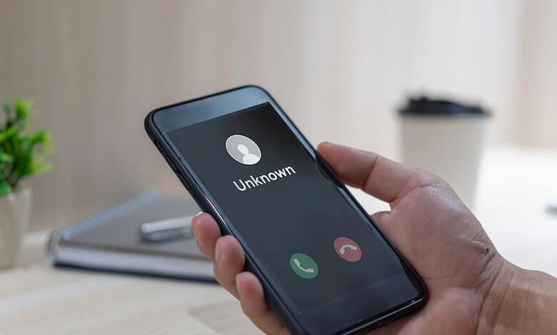 Mobile phone displaying an incoming call from an unknown caller.