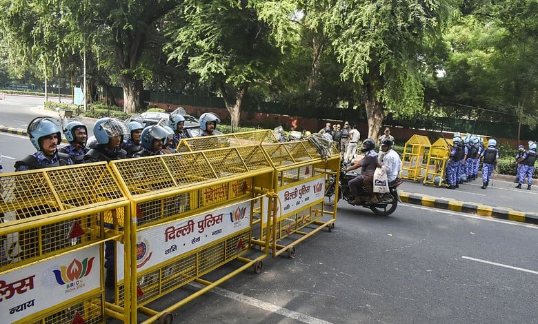 Protesters and police barricades at Jantar Mantar during a demonstration in India.