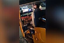 An auto drives uses tow phones while on duty