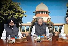 Indian officials at a conference table outside the Supreme Court of India building.