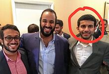 Group of young men in formal attire smiling and celebrating at a social gathering.