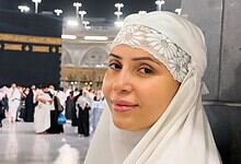 Rozlyn Khan wearing a white hijab at a crowded public gathering.