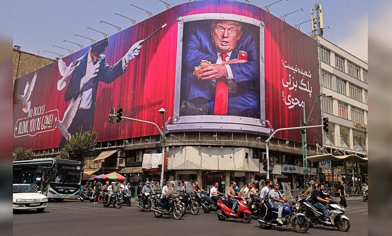 Large billboard in Tehran depicting Donald Trump with a serious expression, surrounded by Iranian text.