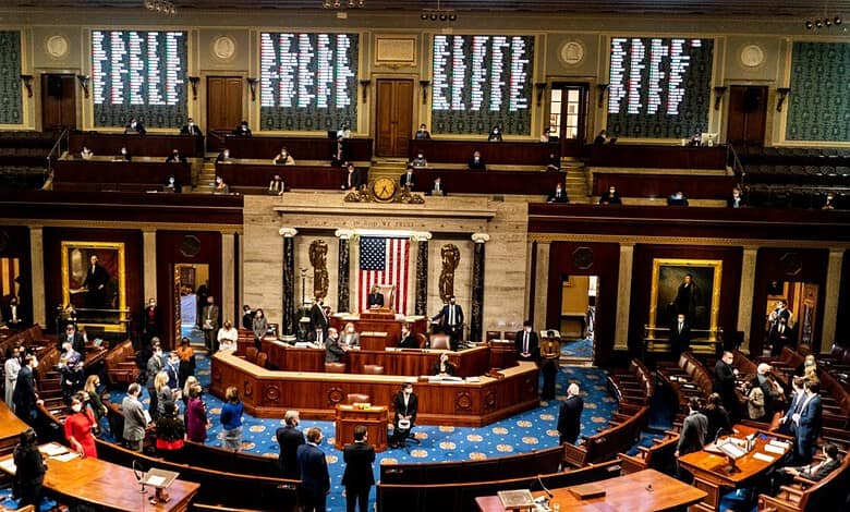 Members of Congress in session with American flags and portraits in the background.