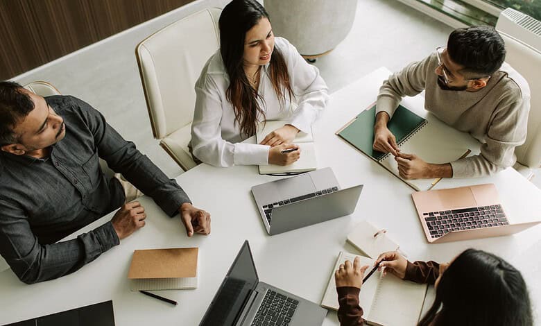 IT professionals discussing work and emergencies during a meeting in Hyderabad office.