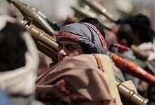Houthi fighters in Yemen armed with rifles and wearing traditional head coverings.